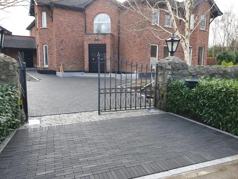 Herringbone driveway through the gates, granite sett border