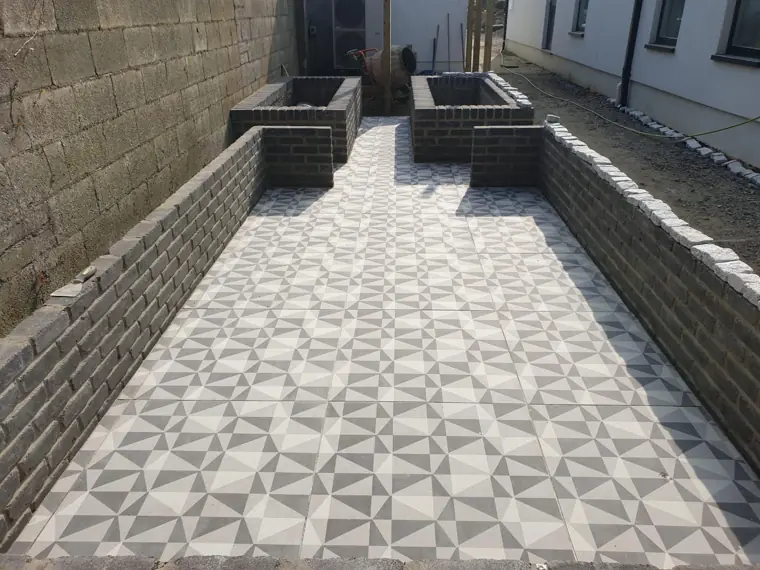 Patterned porcelain courtyard with brick walls