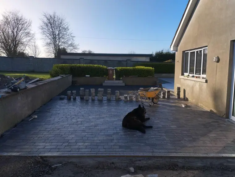 Charcoal block patio with linear drain