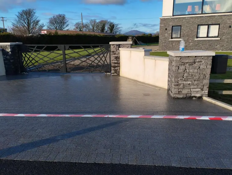 Granite sett driveway with stone-clad pillars