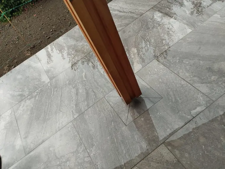Porcelain cut neatly around a timber post