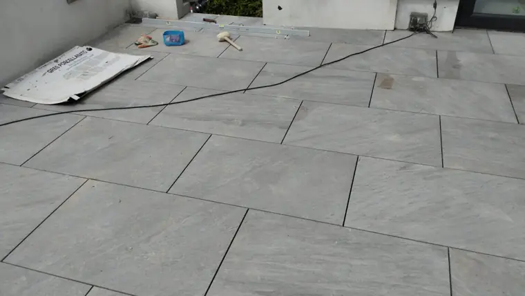 Porcelain being laid on a full bed