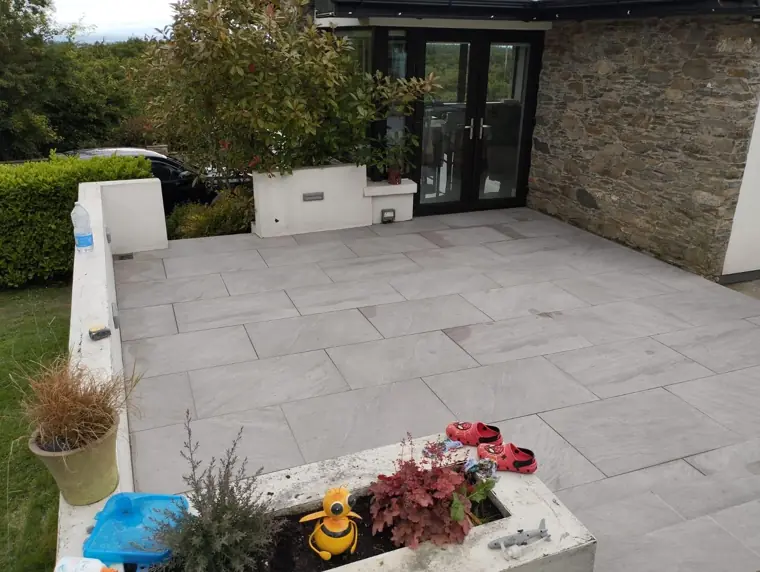 Porcelain patio against a stone wall