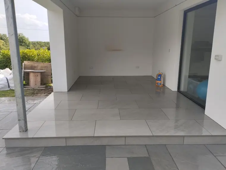 Porcelain step up to a covered porch