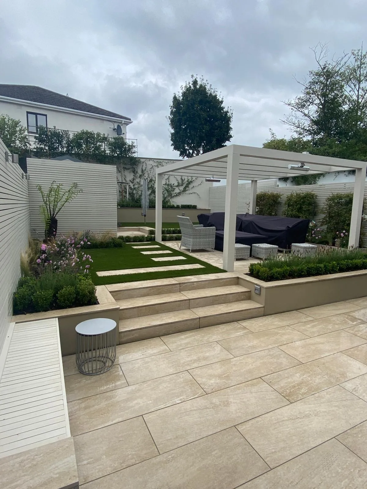 Buff porcelain garden terrace with pergola
